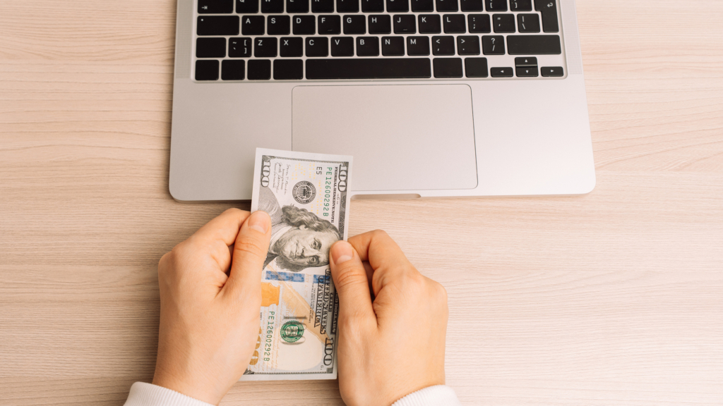 an image of money and laptop