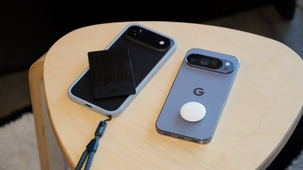 Bluetooth trackers atop an iPhone and Pixel phone.