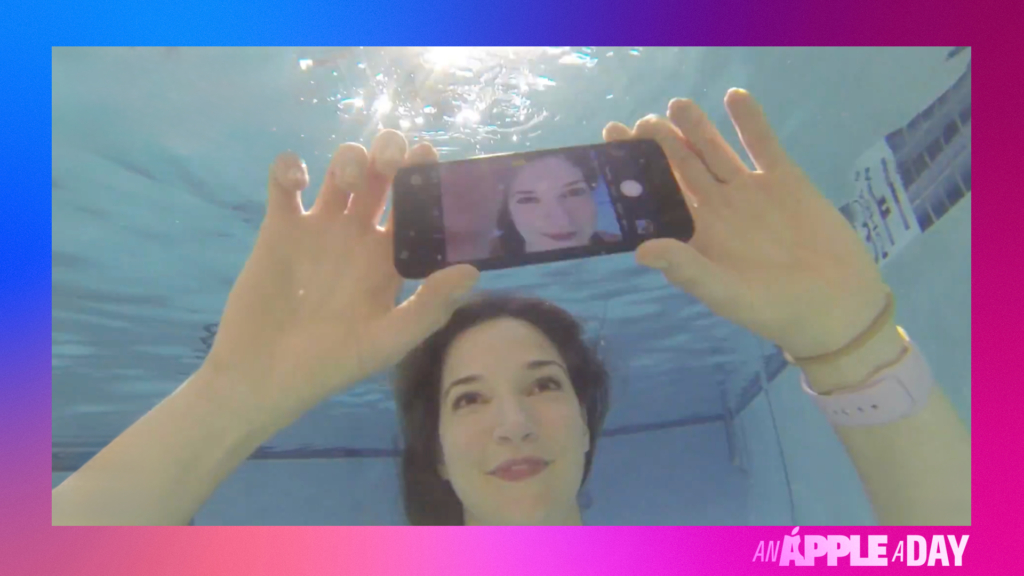 A woman under water taking a selfie with the iPhone 7