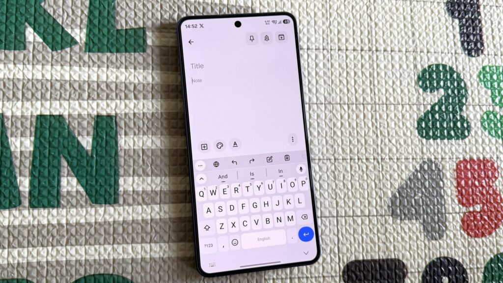 Samsung phone on a matt showing FUTO Keyboard