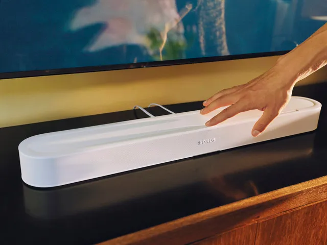 New Sonos Beam Ultra Gets Dolby Atmos Glow Up for $699 The Sonos Beam Ultra on a tabletop being operated by a user