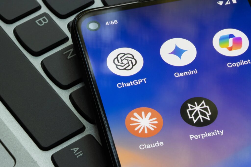 How to Customize Your AI Tools, From ChatGPT to Gemini and Claude A phone with AI apps on it lays on a keyboard.