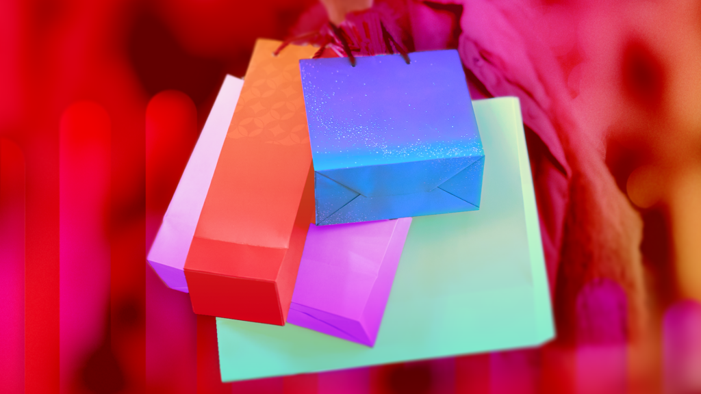 US Adults Have Tighter Holiday Shopping Budgets Amid Rising Tech Costs, CNET Finds colorful gift bags on a red background