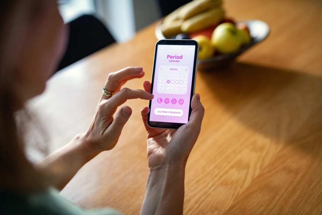 A person tracking their period on an app on their smartphone.