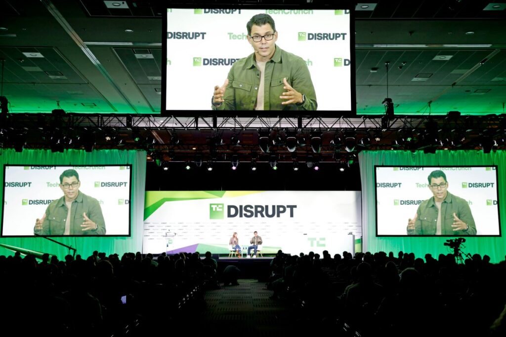 Disrupt 2026: Day 2 | TechCrunch KKirsten Korosec and RJ Scaringe, Founder & CEO, Rivian, speak onstage during TechCrunch Disrupt 2026 at Moscone Center on October 13, 2026 in San Francisco, California