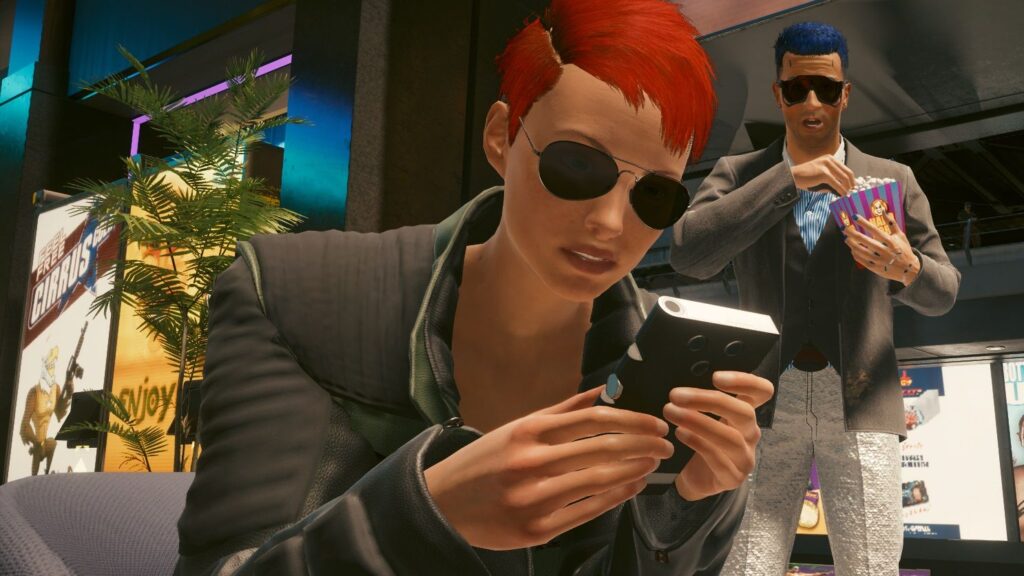 The Cyberpunk 2077 movie won’t be ‘a film adaptation of the game,’ CD Projekt chief says A person on a phone in the future