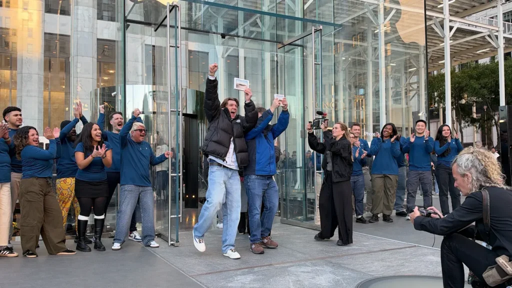 The iPhone Duo Hit Stores Friday. Next Came Long Lines, Sellouts and Resellers Two people cheer that they were able to buy the iPhone Duo at the 5th Avenue Apple store.